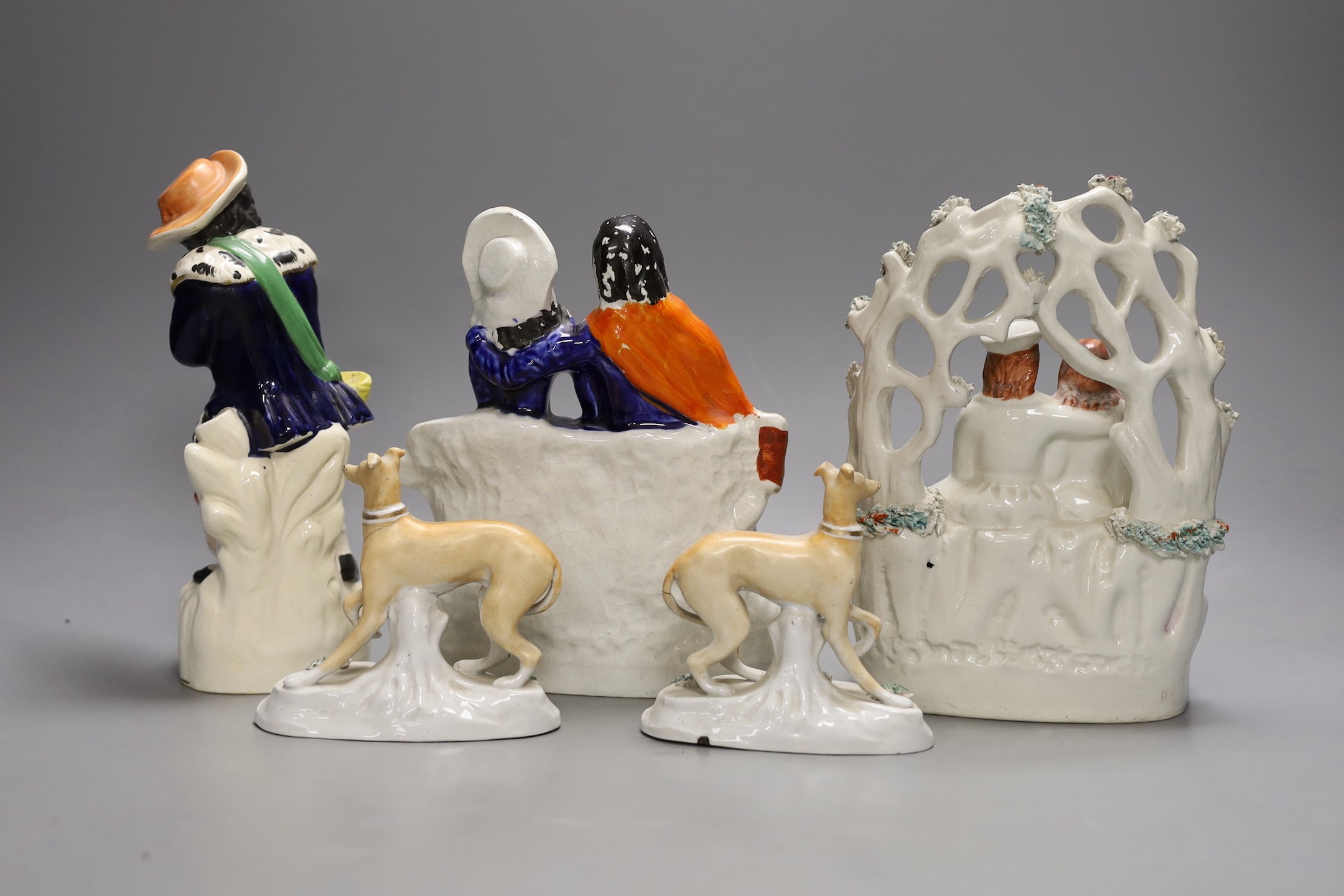 A pair of Victorian Staffordshire greyhounds and three Staffordshire pottery figures or groups - tallest 21.5cm